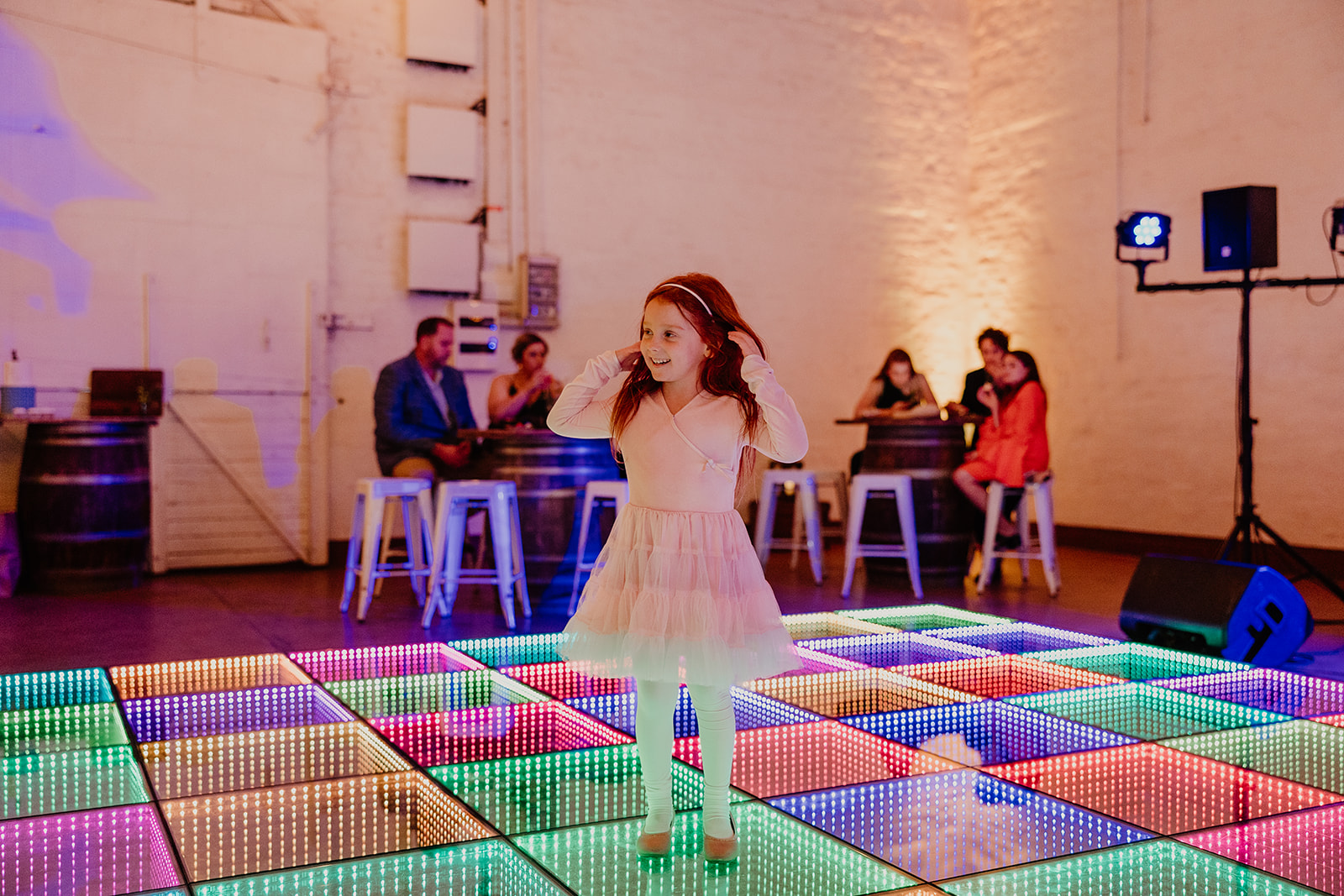 Young guest dancing on the glowing 3D infinity dance floor at a Perth wedding