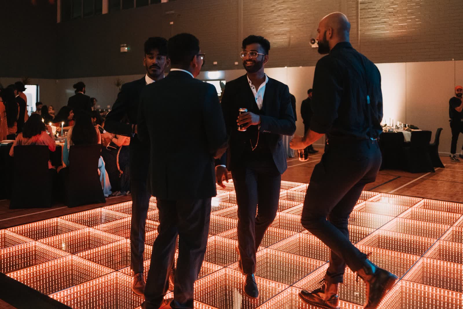 Guests dancing on the glowing 3D infinity dance floor at a Perth event